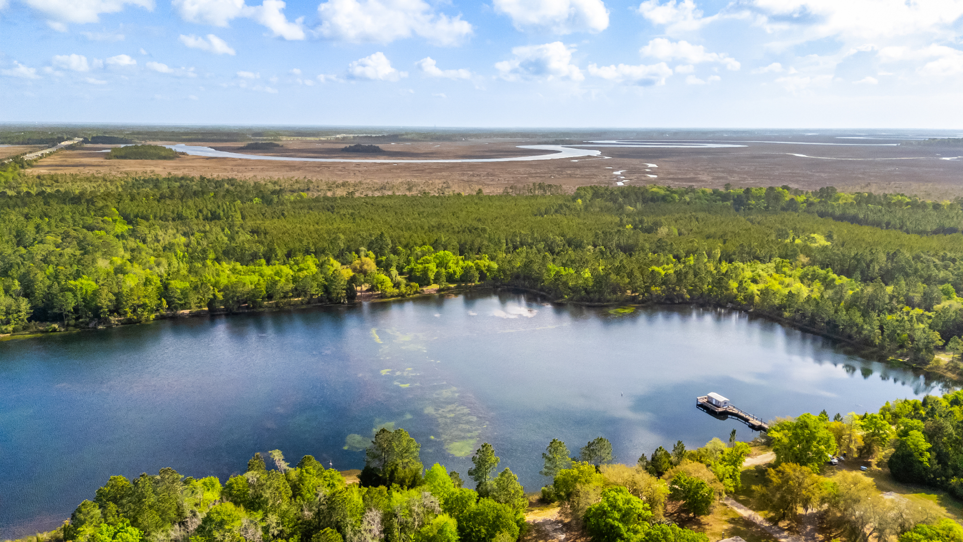 The Terra Lake dock and pine-lined shoreline on a bright afternoon